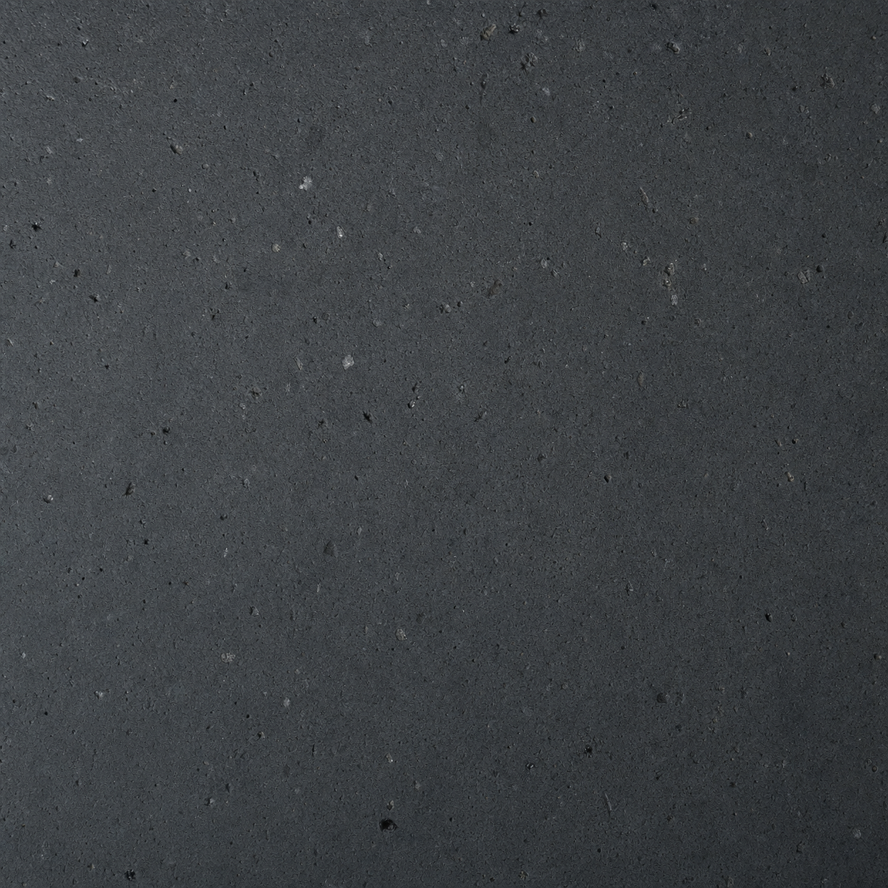 Honed basalt stone in deep charcoal with mineral pitting