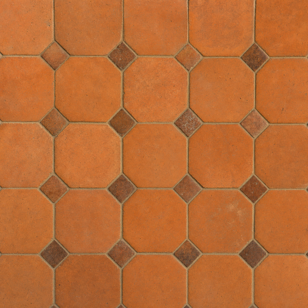 Hand-laid antique terracotta floor tiles in warm rust orange